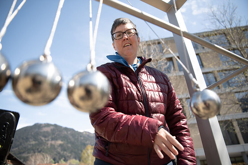 Person playing with acoustic balls in playground